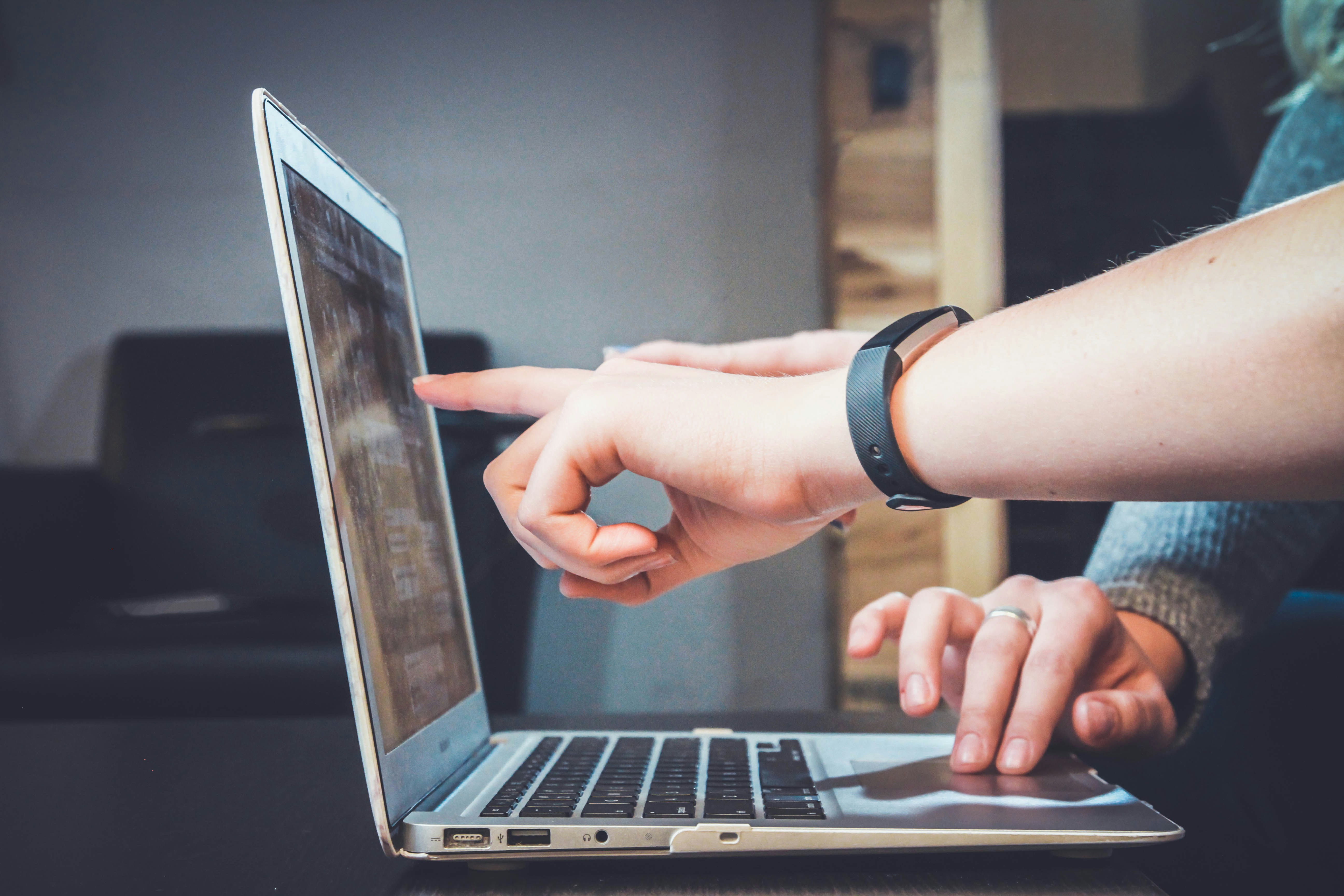 Consultant reviewing website strategy on a laptop